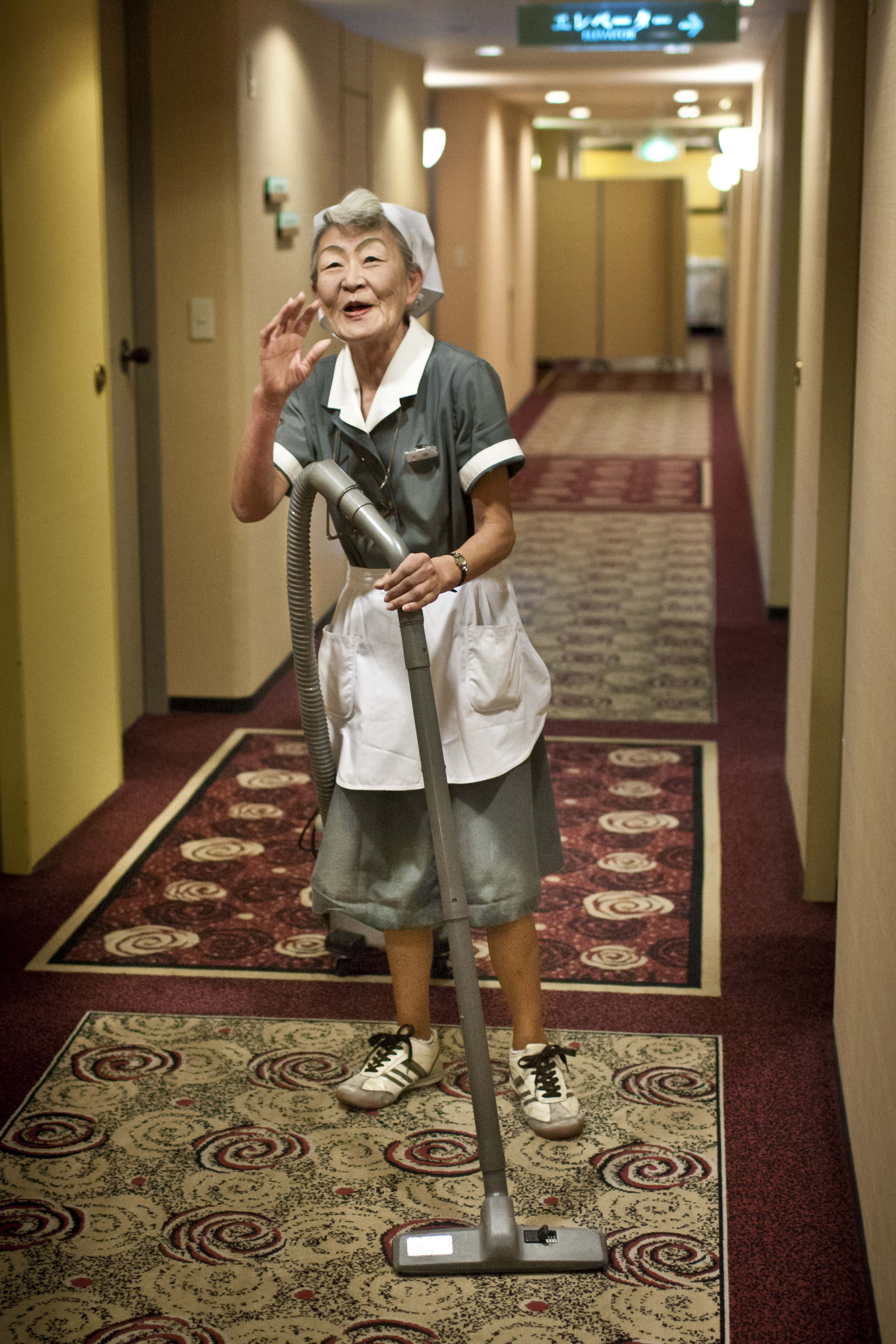 A hotel maid in hallway in Japan
